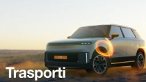 A light-colored SUV stands in a desert landscape at sunset, with a glowing light-ring effect over the front wheel. The text reads: "Transport."