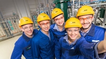 Five BASF employees wearing protective equipment and yellow helmets  Five BASF employees wearing protective equipment and yellow helmets