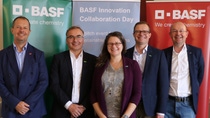5 BASF experts standing in front of BASF banners