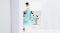 Lab technician in uniform hurries through laboratory rooms Lab technician in uniform hurries through laboratory rooms