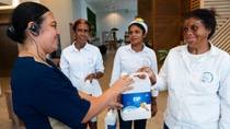 4 women handling a product sample. 4 women handling a product sample.