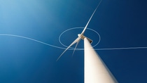 Wind turbine against a blue sky photographed from below Wind turbine against a blue sky photographed from below