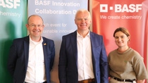 Three people standing in front of 3 BASF banners