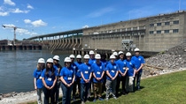 A group of students standing by the river