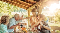 Portait of a big family having a picnic at a vineyard