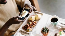 Einen Person macht mit einem Smartphone ein Bild von seinem Essen. Einen Person macht mit einem Smartphone ein Bild von seinem Essen.