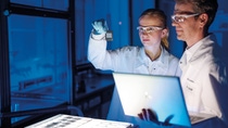 In einem frühen Stadium der Produktentwicklung ist es wichtig zu verstehen, ob und wie der biologische Abbau abläuft. BASF entwickelt eine Reihe zertifizierter biologisch abbaubarer Produkte, die in zahlreichen Anwendungen zum Einsatz kommen, darunter bodenabbaubare Mulchfolien für die Landwirtschaft, kompostierbare Beutel und Haushalts- und Körperpflegeprodukte. Dabei nutzen BASF-Forscher verschiedene Methoden, mit denen sich der biologische Abbau eines Materials in verschiedenen Lebensräumen messen lässt.
Bei kompostierbaren und im Boden biologisch abbaubaren Produkten muss sichergestellt werden, dass diese Produkte nicht nur biologisch abbaubar sind, sondern dass auch zusätzlich untersucht wird, wie die Desintegration unter standardisierten End-of-Life-Bedingungen abläuft. Für Folienprodukte werden in der Regel Diarahmen verwendet, die die Folie einige Tage lang in einer speziellen Umgebung aufbewahren, so dass die Testproben gut entnommen werden können. Das Ausmass der Desintegration wird dann mit automatischen Analysealgorithmen ausgewertet.
Constanze Risse (links), Spezialistin für Labordigitalisierung, und Waldemar Bartuli (rechts), Laborant, analysieren Proben aus einem Bodenabbaubarkeitsversuch an einem Lichtkasten In einem frühen Stadium der Produktentwicklung ist es wichtig zu verstehen, ob und wie der biologische Abbau abläuft. BASF entwickelt eine Reihe zertifizierter biologisch abbaubarer Produkte, die in zahlreichen Anwendungen zum Einsatz kommen, darunter bodenabbaubare Mulchfolien für die Landwirtschaft, kompostierbare Beutel und Haushalts- und Körperpflegeprodukte. Dabei nutzen BASF-Forscher verschiedene Methoden, mit denen sich der biologische Abbau eines Materials in verschiedenen Lebensräumen messen lässt.
Bei kompostierbaren und im Boden biologisch abbaubaren Produkten muss sichergestellt werden, dass diese Produkte nicht nur biologisch abbaubar sind, sondern dass auch zusätzlich untersucht wird, wie die Desintegration unter standardisierten End-of-Life-Bedingungen abläuft. Für Folienprodukte werden in der Regel Diarahmen verwendet, die die Folie einige Tage lang in einer speziellen Umgebung aufbewahren, so dass die Testproben gut entnommen werden können. Das Ausmass der Desintegration wird dann mit automatischen Analysealgorithmen ausgewertet.
Constanze Risse (links), Spezialistin für Labordigitalisierung, und Waldemar Bartuli (rechts), Laborant, analysieren Proben aus einem Bodenabbaubarkeitsversuch an einem Lichtkasten