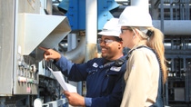 BASF employee training another employee at a plant control panel