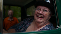 Close up of an elderly woman sitting in a green car. Close up of an elderly woman sitting in a green car.