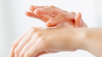 Hand hydration. Healthy skin. Cosmetic moisturizing. Closeup of woman soft palms applying nourishing cream product isolated on light background.