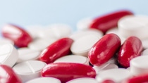 pile of white pills and red capsules on blue medical background; Shutterstock ID 1806373093; purchase_order: BASF_PHA-002753; job: Main_Product_Catalog; client: BASF Pharma Solutions; other: Katharina Weber