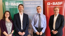 Four people standing in front of BASF banners.jpg Four people standing in front of BASF banners.jpg