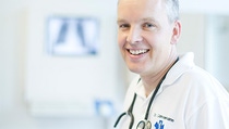 Medical personnel with a stethoscope smiling at the camera  Medical personnel with a stethoscope smiling at the camera
