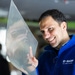 Dr. Sebastian Hartwig in a blue BASF jacket, smiling as he analyses a piece of sharkskin film.  Dr. Sebastian Hartwig in a blue BASF jacket, smiling as he analyses a piece of sharkskin film.