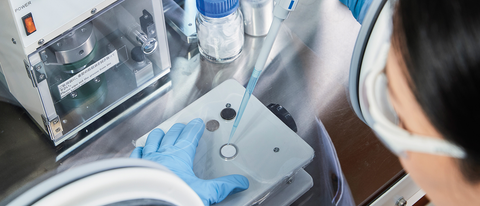 Scientist in a lab performing an experiment Scientist in a lab performing an experiment