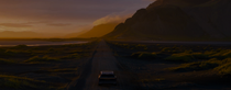 A car in a mountainous landscape driving into the sunset. A car in a mountainous landscape driving into the sunset.