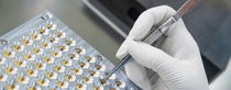 BASF’s start-up, trinamiX, develops and produces miniaturized infrared sensors named Hertzstück™. The sensors can be used for various applications such as gas sensing, flame control or near-infrared-spectroscopy. Thanks to their small footprint and high availability, they are also applicable to consumer applications. The sensors are offered in various pack-agings. The photo shows how the sensors are prepared for further processing. As the sensors are sensitive to dust they are processed in the cleanroom of trinamiX. 