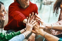 A group of scientists in lab coats walk through a modern corridor.