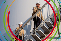 A man and a woman are walking up a flight of stairs.