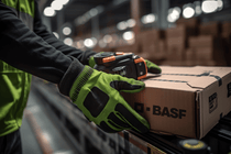 person moving basf box in production site