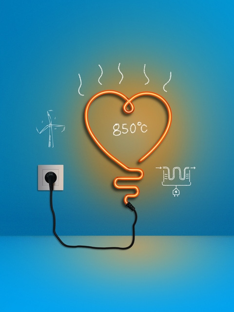 L’image montre un néon orange en forme de cœur branché sur un mur bleu. Autour de lui, des croquis blancs représentent une éolienne, un élément chauffant électrique et le chiffre « 850 °C ». 