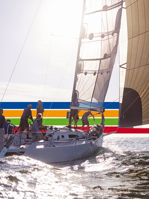 People on a sailing boat in the ocean, under a bright sky, surrounded by a key visual of four lines in blue, orange, green and red (photoshopped) People on a sailing boat in the ocean, under a bright sky, surrounded by a key visual of four lines in blue, orange, green and red (photoshopped)