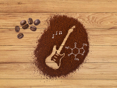 Electric guitar drawn as an outline in a heap of coffee grounds