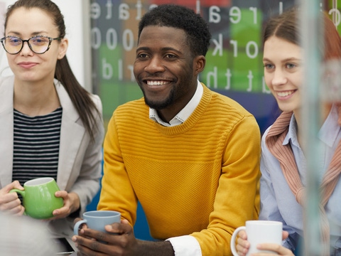 A group of young people sit together.