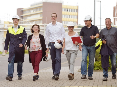 7 Mitarbeitende in Arbeitskleidung am Standort Münster