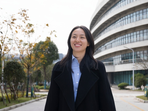 A woman walking towards the camera and smiling A woman walking towards the camera and smiling