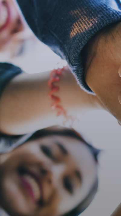 People of different origins and skin color put their hands on top of each other