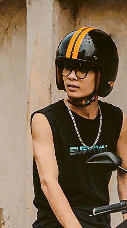 Man sitting on a stationary moped  Man sitting on a stationary moped