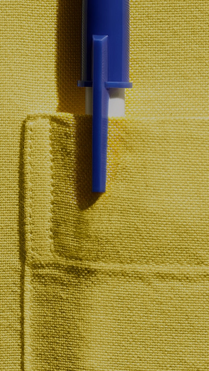 Pen in breast pocket, yellow shirt.