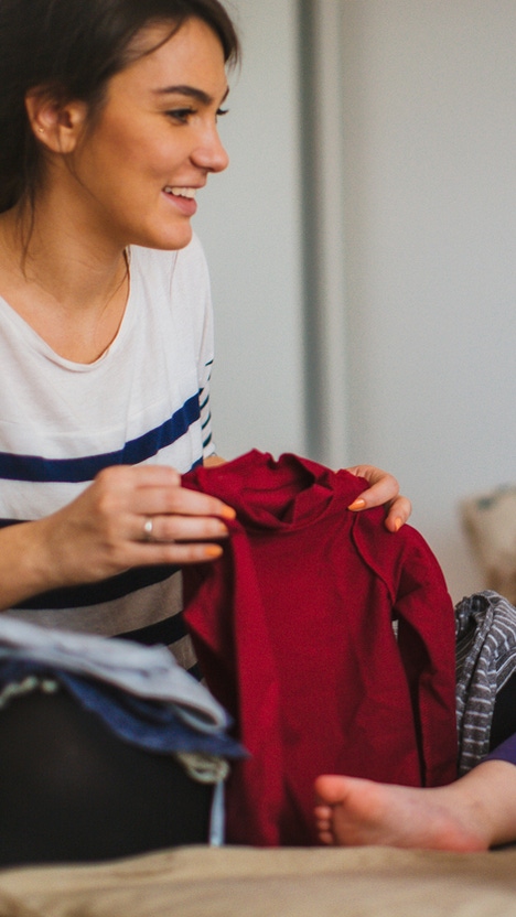 Mother and her daughter folding laundry together Mother and her daughter folding laundry together