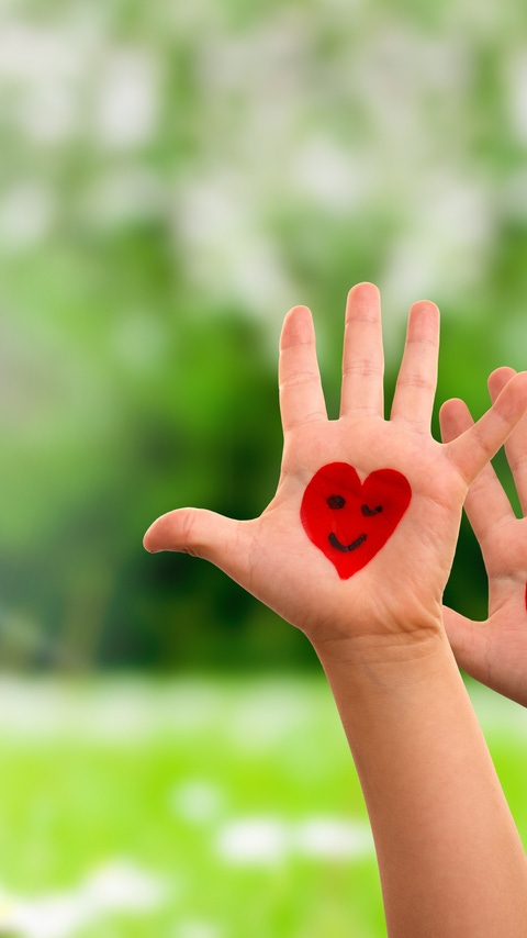 Many Kids Hands Showing Red Heart Symbols And Smileys. Grass Meadow As Background