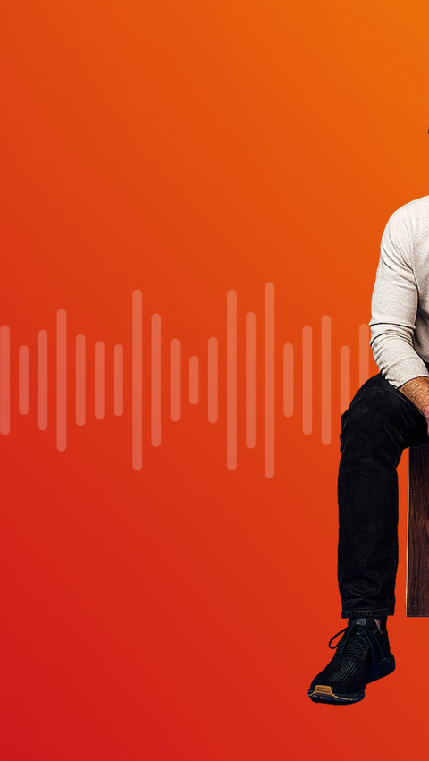 A man sits on a wooden stool in front of a red-to-orange gradient background with stylized sound waves stretching horizontally across the image.