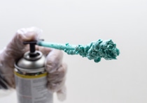 Worker hand holding polyurethane expanding foam glue gun. Worker hand holding polyurethane expanding foam glue gun.