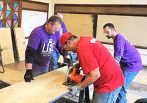 BASF employees cut subflooring to lay inside the Durfee Innovation Society.