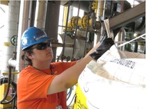 Brandon Threadgill, ASCC intern, loads product bags in the Light Stabilizers Unit.