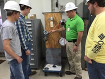 BASF Maintenance Supervisor Shane Thornton shows Tristen Koen, Josh Gunn and Glenn Moore of Millry High School equipment in the Antioxidants Unit.