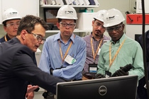 Sven Wagner, Manager, Safety Engineering at BASF Wyandotte, and faculty look at a safety process during a tour of one of the laboratories on site.