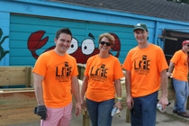 BASF employees build planter boxes for flowers to brighten the Denby High School grounds.