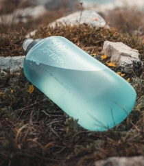 Flexible sports water bottle in a natural setting. 