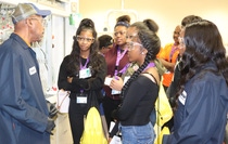 BASF Research Technician Roosevelt White (left) talks with high school students about his job in the laboratory.
