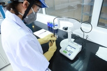 A lab technician testing products for quality control at the concrete admixtures production plant in Bac Giang, Vietnam