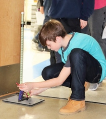 Student William Heskett adjusts the angle on a rocket launcher to change its trajectory. Heskett is a seventh-grade student in the Wyandotte Public Schools STEM program.