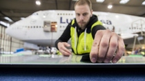 Lufthansa technician applies sharkskin film Lufthansa technician applies sharkskin film