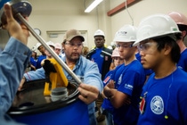 Taylor Heath, BASF Instrument Technician, demonstrates a level indicator used to transmit drum level signals to the operations personnel during the TECH Academy visit to BASF’s Geismar site. Taylor Heath, BASF Instrument Technician, demonstrates a level indicator used to transmit drum level signals to the operations personnel during the TECH Academy visit to BASF’s Geismar site.