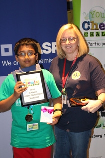 Santosh Sadasiuam, a sixth grade student at Columbia Elementary School, stands with his science teacher as he was recognized as the State Champion