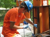 Zane Warr, ASCC intern, performs field analysis and comprehensive sampling of groundwater wells.